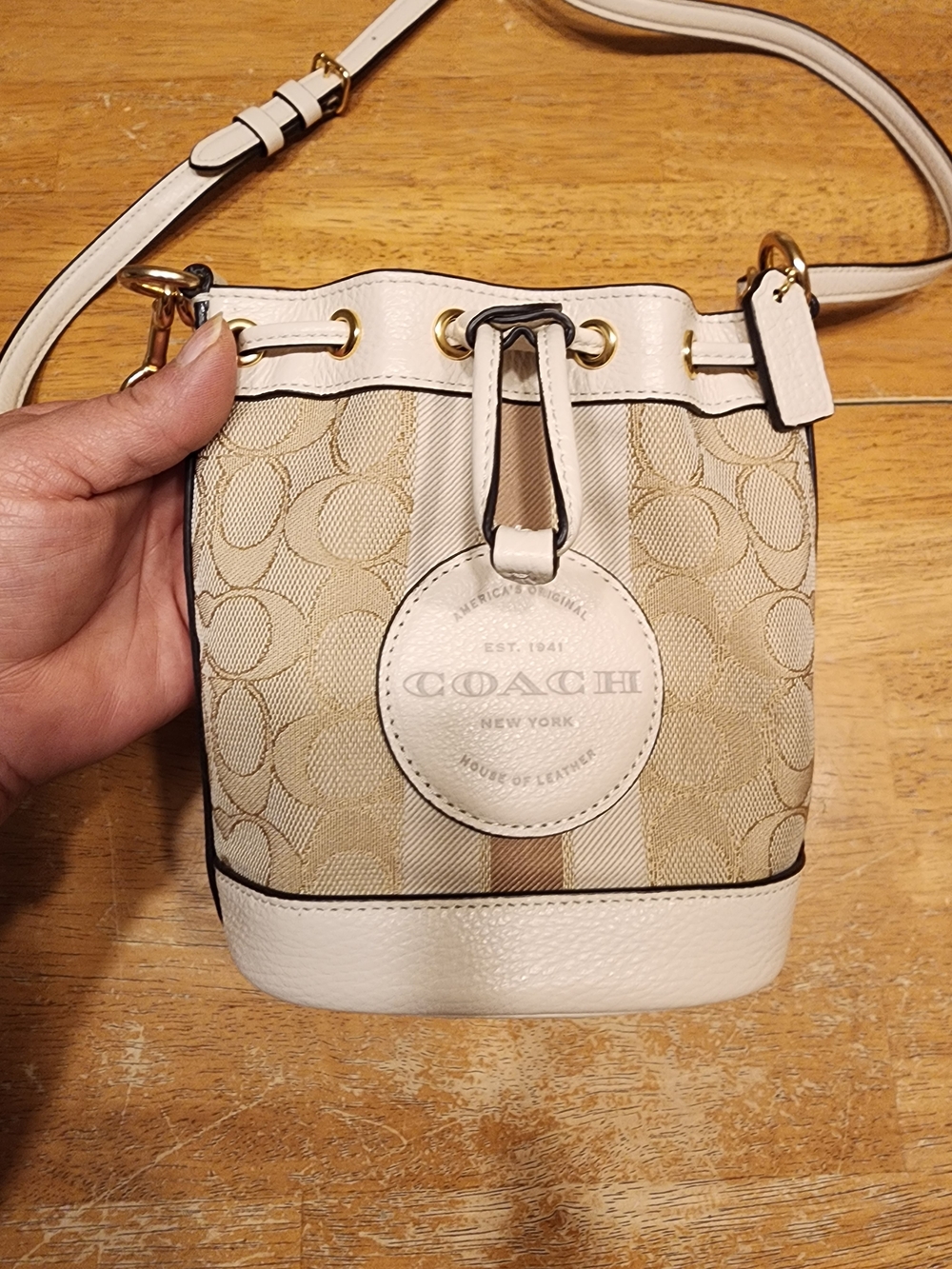 Coach Mini Dempsey Bucket Bag features signature jacquard canvas in light khaki